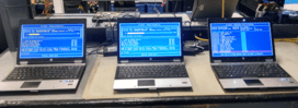 Three laptops displaying blue screens